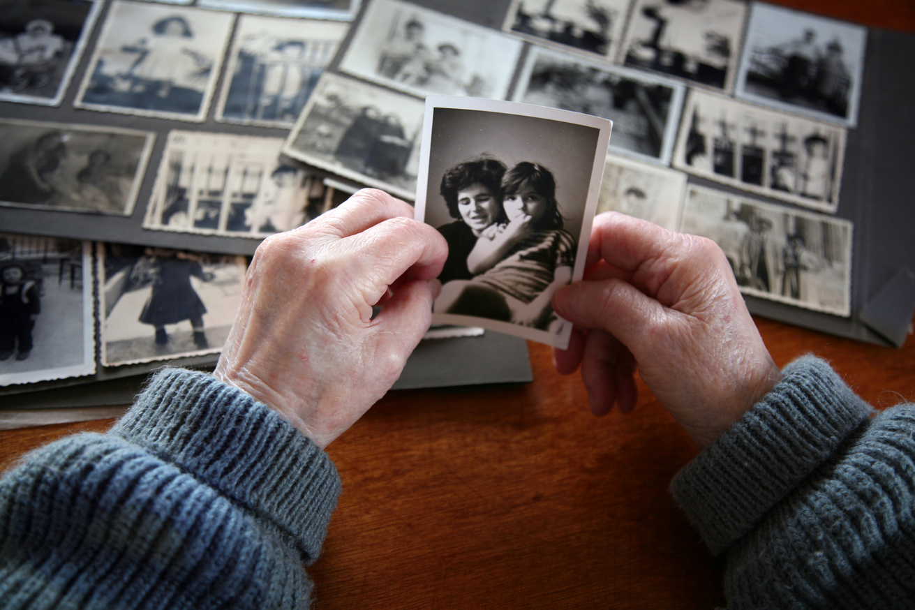 Elderly man seeing photos of friends and families.